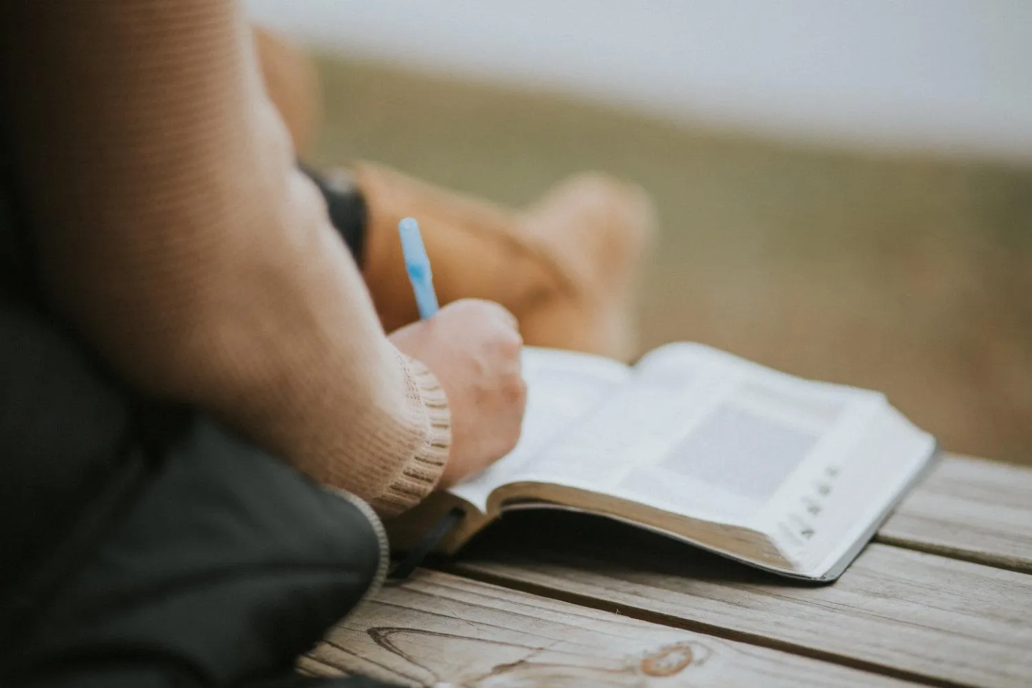 Daily devotional book paired with an open Bible for morning study